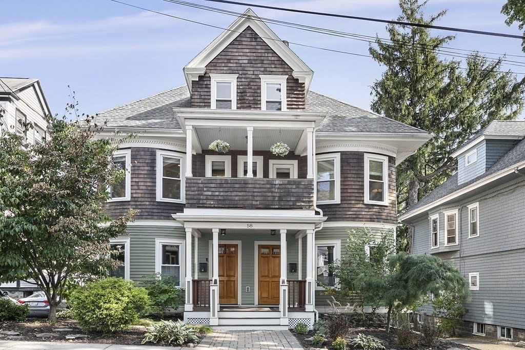 58 Liberty Avenue, Unit 2 Somerville, MA 02144 - Photo 22 of 22 a view of a white house with large windows and a small yard
