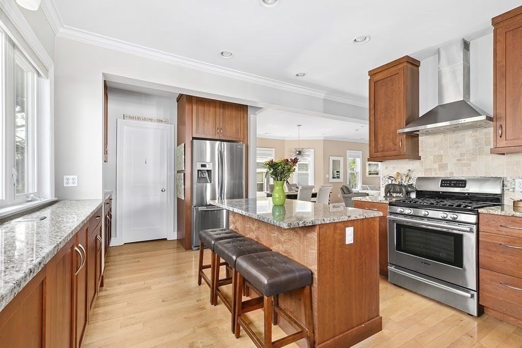 58 Liberty Avenue, Unit 2 Somerville, MA 02144 - Photo 5 of 22 a kitchen with stainless steel appliances granite countertop a stove a sink and a refrigerator