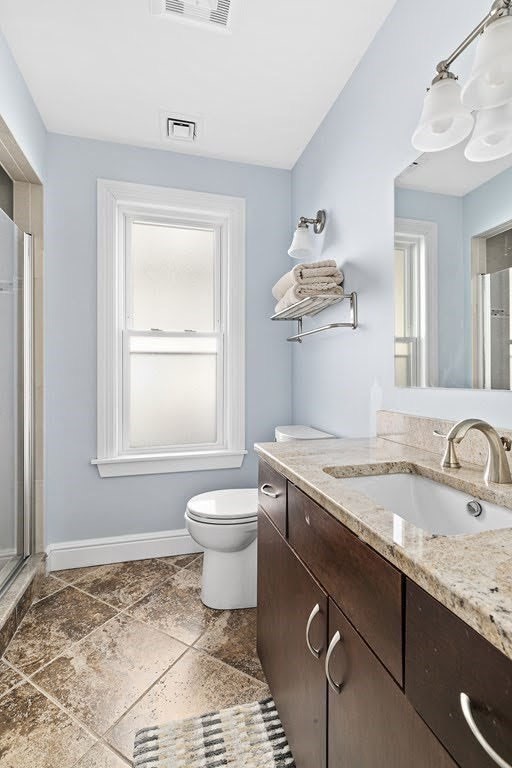 58 Liberty Avenue, Unit 2 Somerville, MA 02144 - Photo 9 of 22 a bathroom with a granite countertop sink a toilet and a window