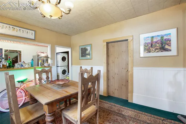 a view of a dining room with furniture and a chandelier