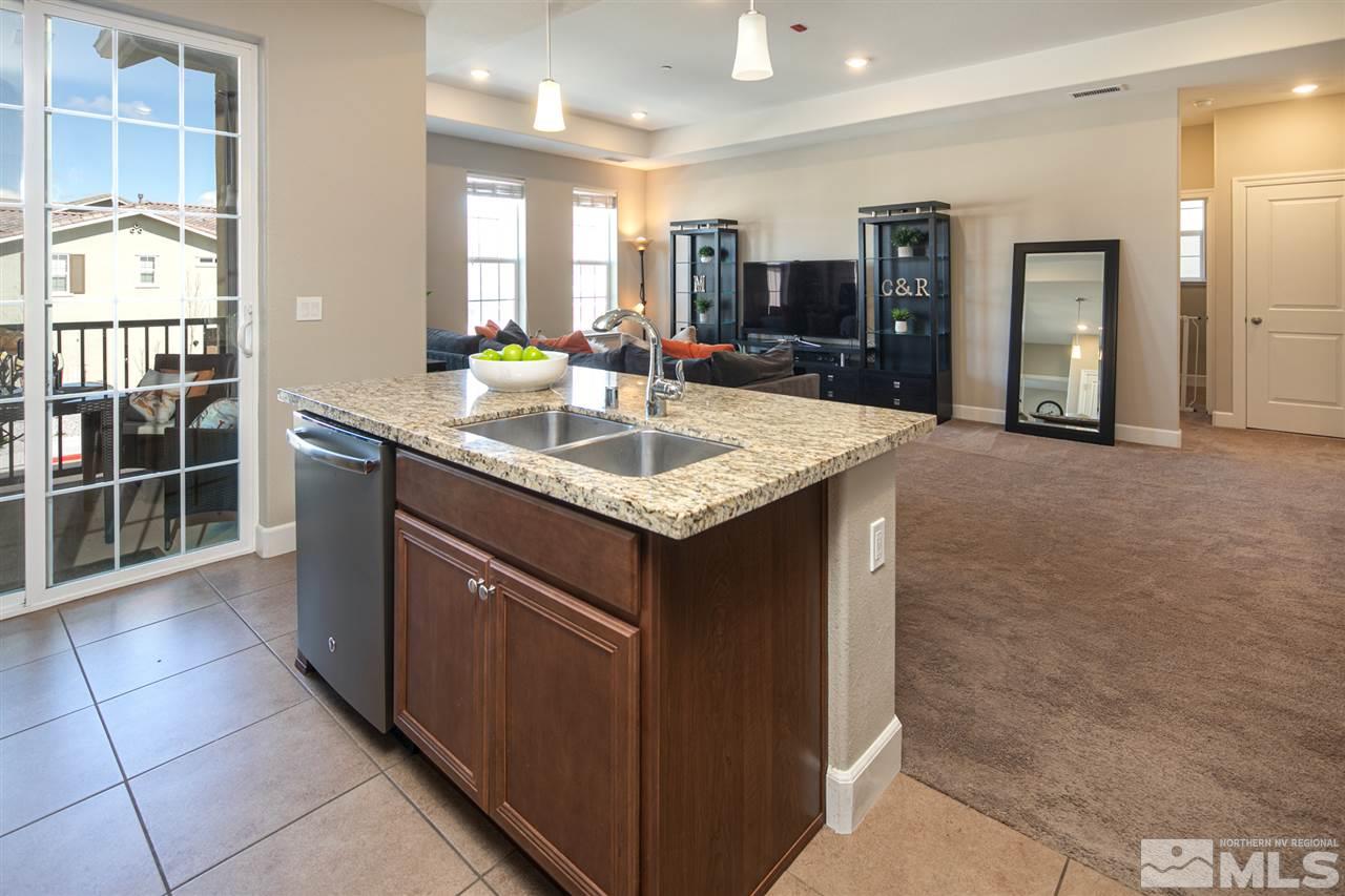 2032 Wind Ranch Road, Unit A Reno, NV 89521 - Photo 8 of 24 a kitchen with kitchen island granite countertop a sink and cabinets