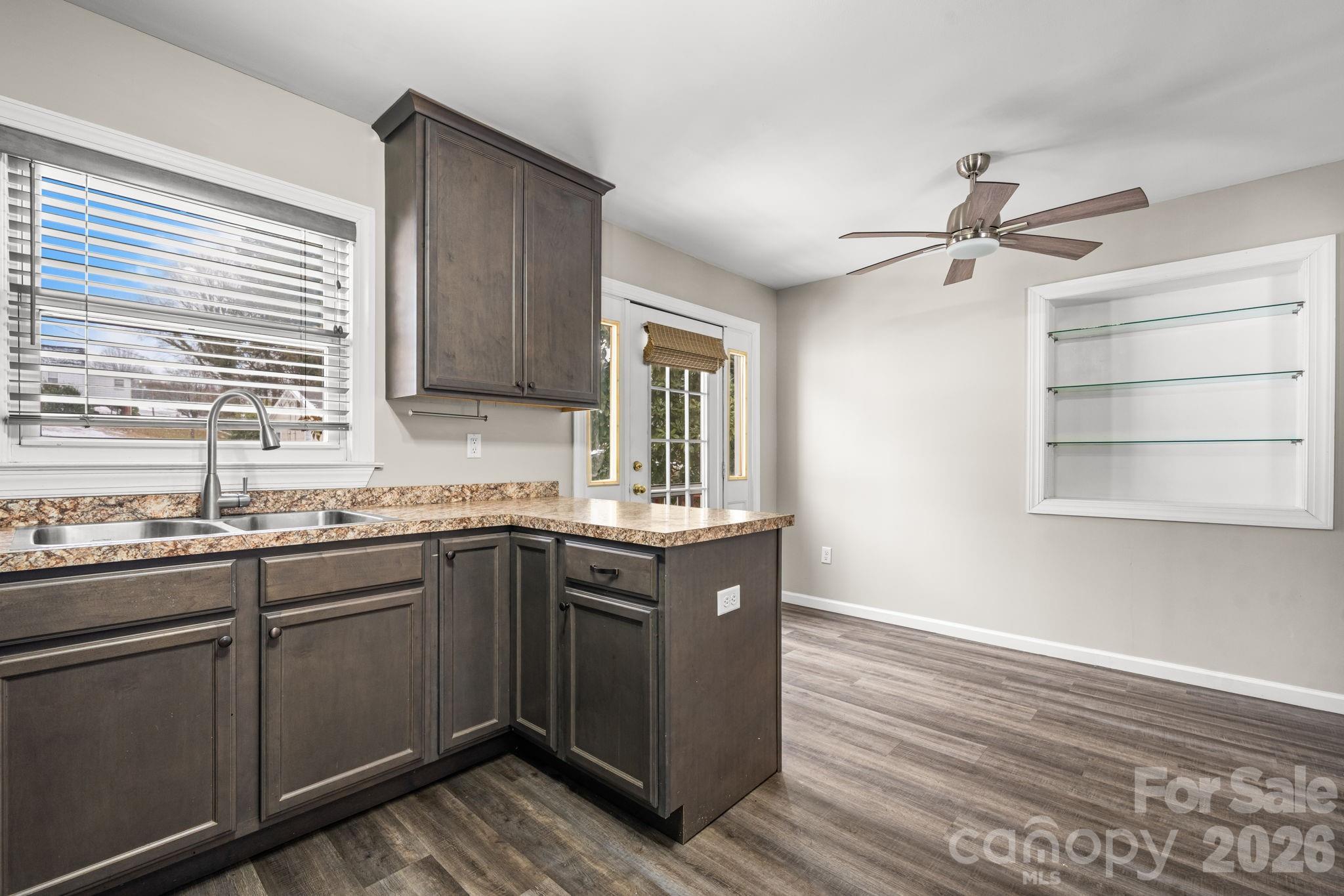 203 3rd Avenue Northeast Conover, NC 28613 - Photo 22 of 30 a kitchen with stainless steel appliances granite countertop a sink and wooden cabinets