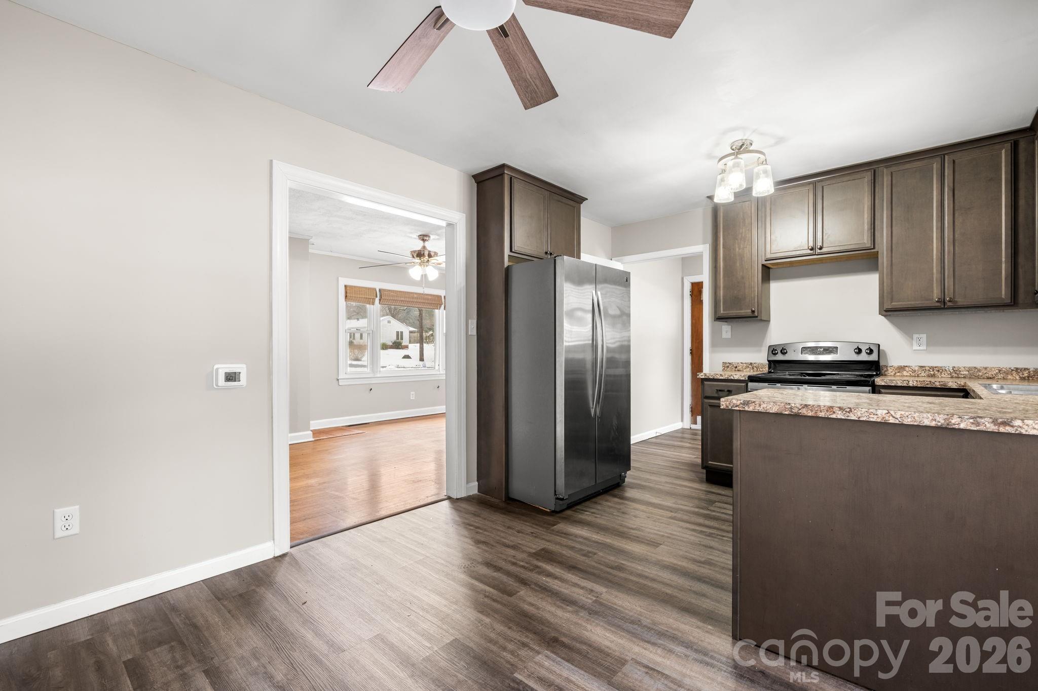 203 3rd Avenue Northeast Conover, NC 28613 - Photo 24 of 30 a kitchen with granite countertop a refrigerator and a stove