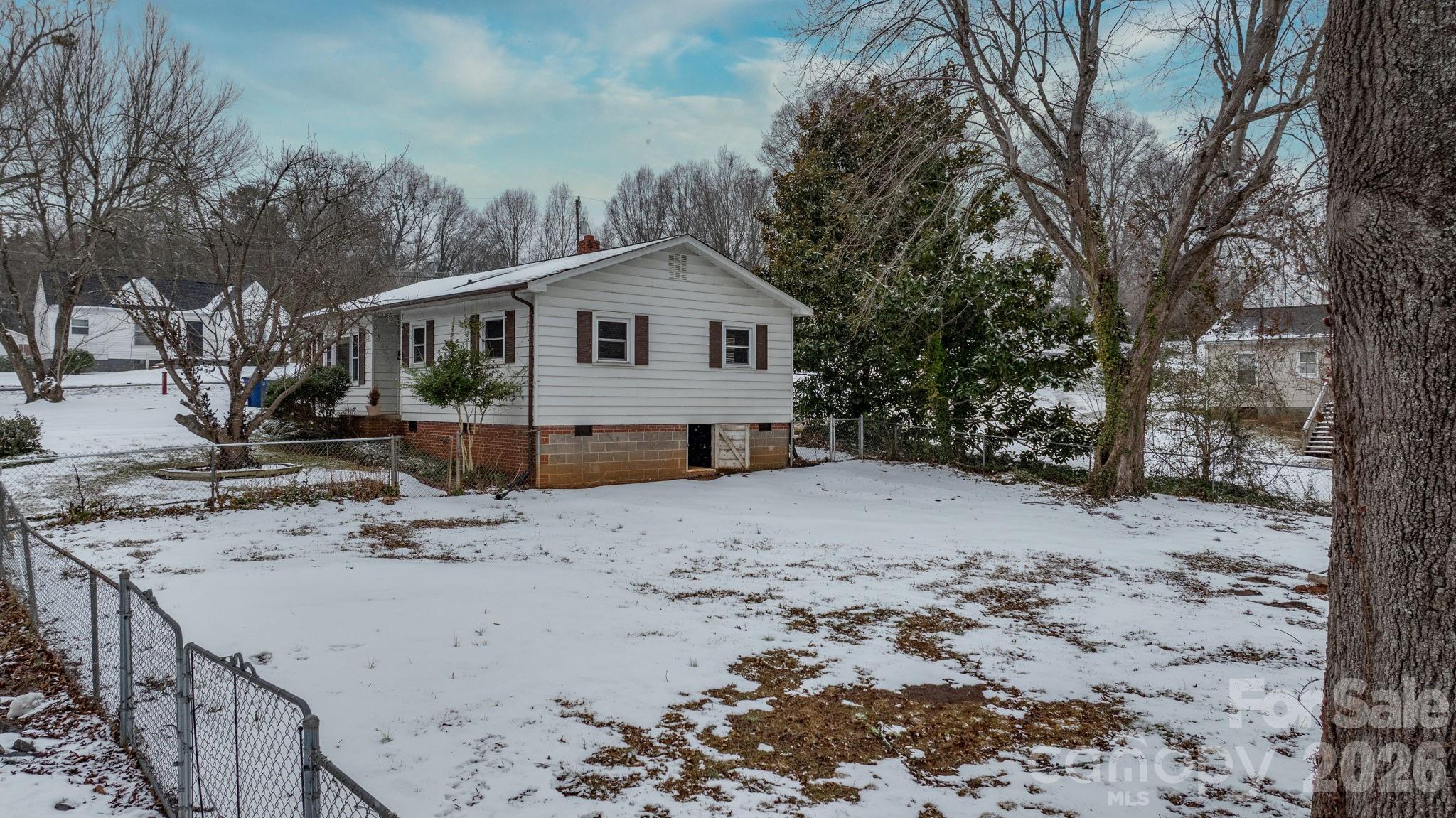 203 3rd Avenue Northeast Conover, NC 28613 - Photo 5 of 30 a view of a house with a yard covered in snow