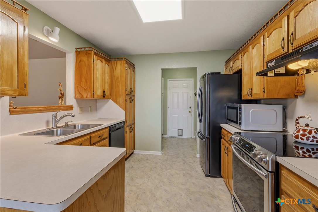 261 County Road 4963 Kempner, TX 76539 - Photo 18 of 44 a kitchen with a sink stove and refrigerator