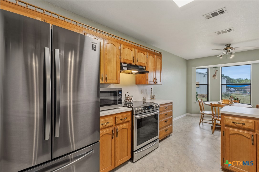 261 County Road 4963 Kempner, TX 76539 - Photo 19 of 44 a kitchen with stainless steel appliances granite countertop a sink stove and refrigerator