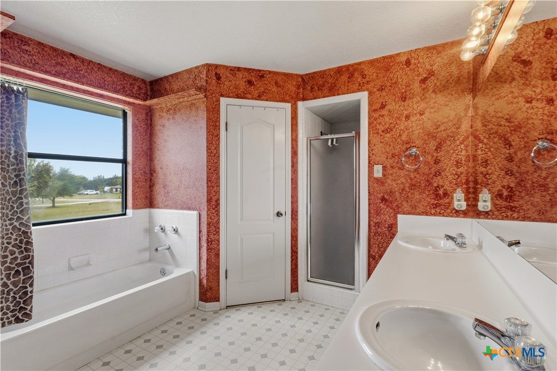 261 County Road 4963 Kempner, TX 76539 - Photo 26 of 44 a bathroom with a tub and a shower