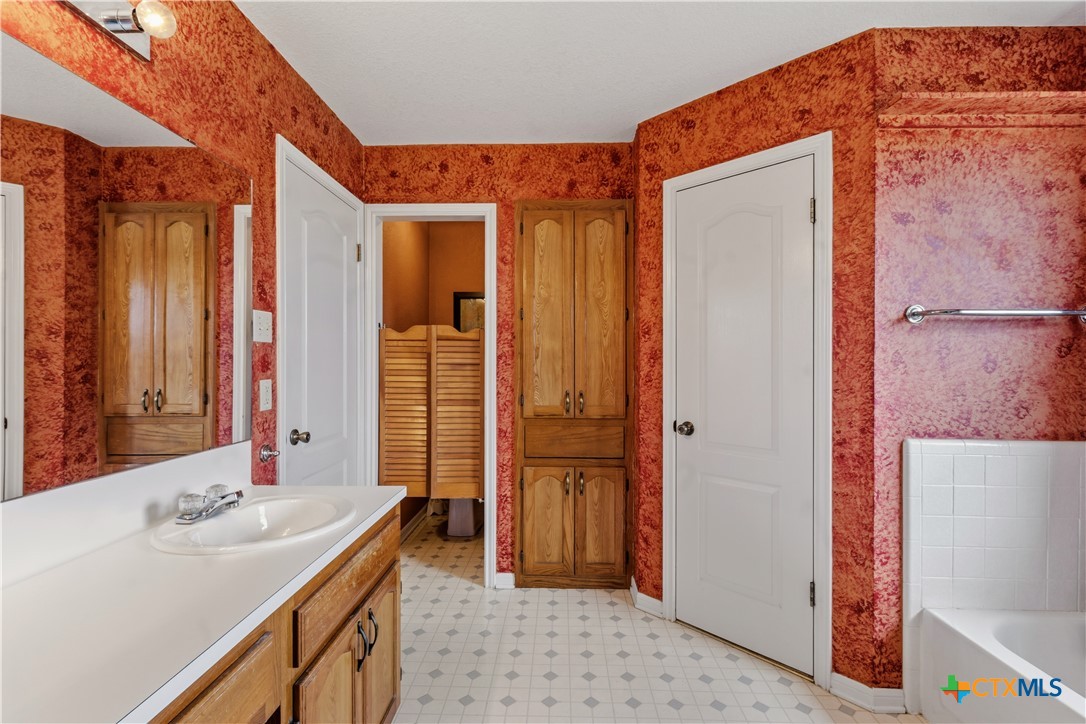 261 County Road 4963 Kempner, TX 76539 - Photo 27 of 44 a bathroom with a sink a mirror and a shower