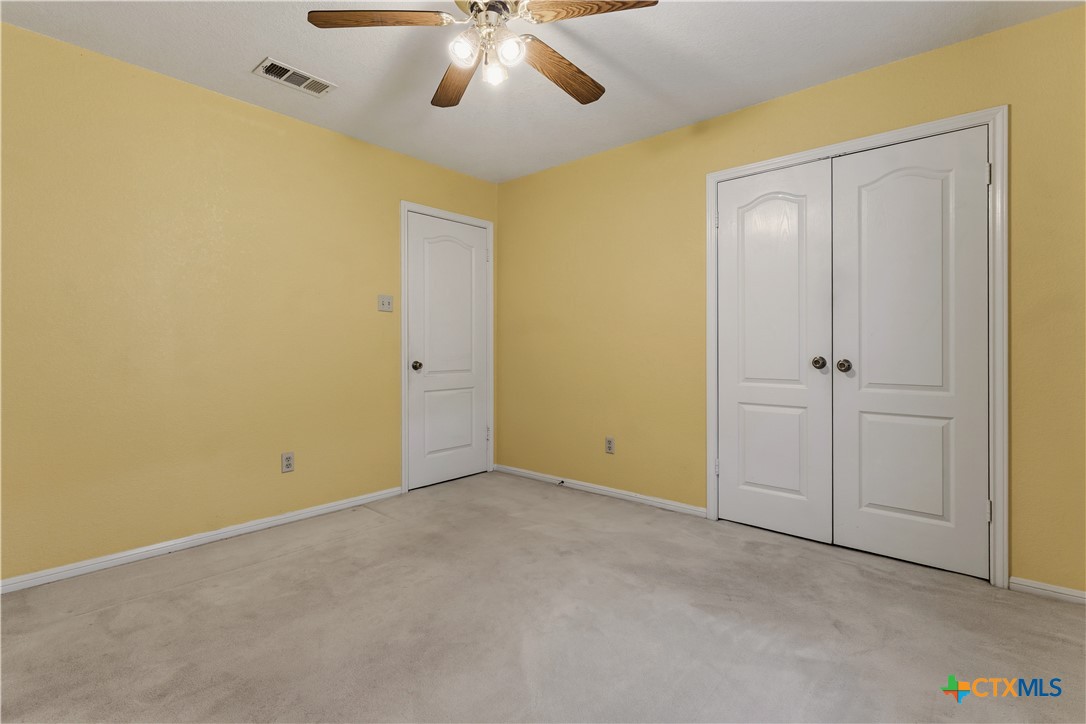 261 County Road 4963 Kempner, TX 76539 - Photo 33 of 44 an empty room with a chandelier fan and closet