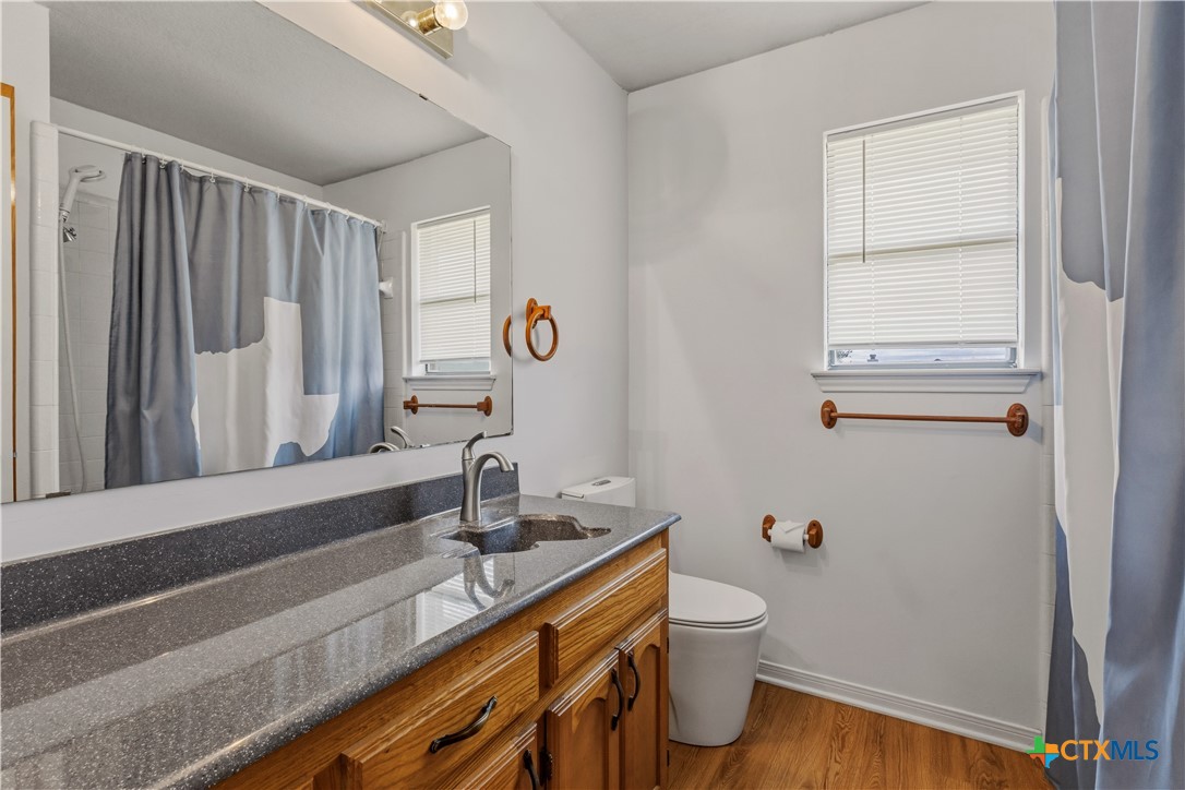 261 County Road 4963 Kempner, TX 76539 - Photo 34 of 44 a bathroom with a granite countertop sink toilet and shower