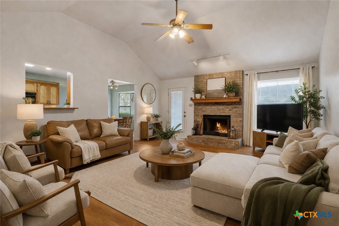 261 County Road 4963 Kempner, TX 76539 - Photo 10 of 44 a living room with furniture a fireplace and a flat screen tv