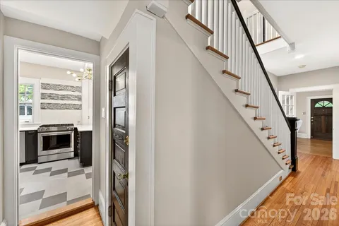 a view of a livingroom with wooden floor and stairs