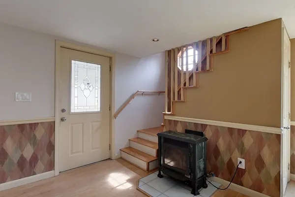 a view of entryway and hall with wooden floor