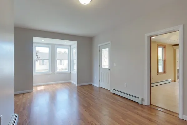 wooden floor in an empty room with a window