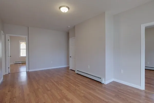 a view of an empty room and wooden floor