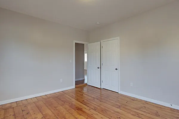 a view of an empty room and wooden floor