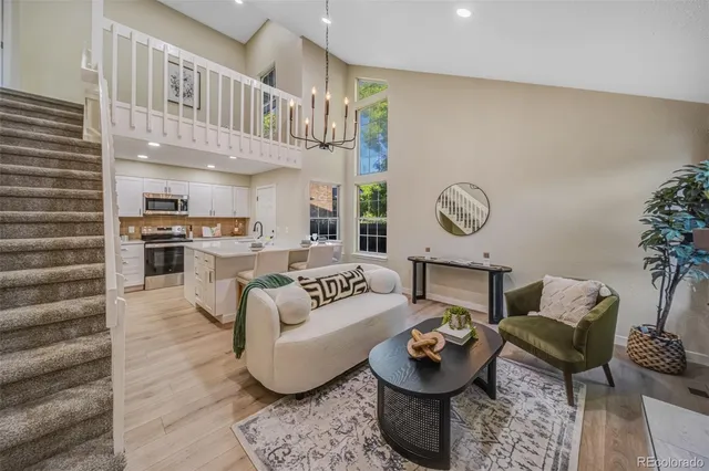 a living room with furniture and kitchen view
