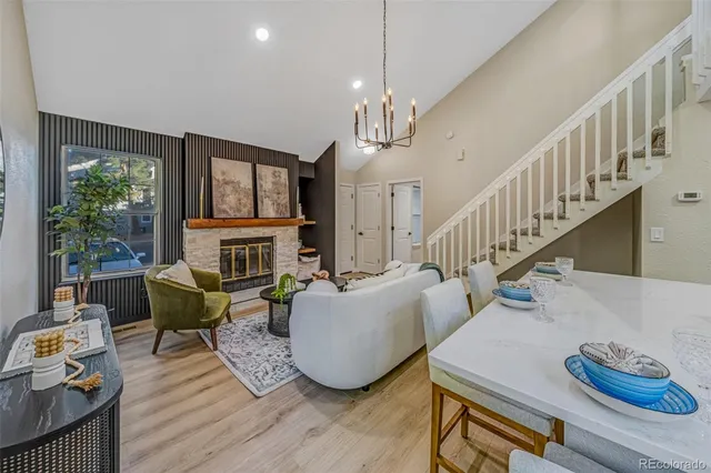 a living room with fireplace furniture and a wooden floor
