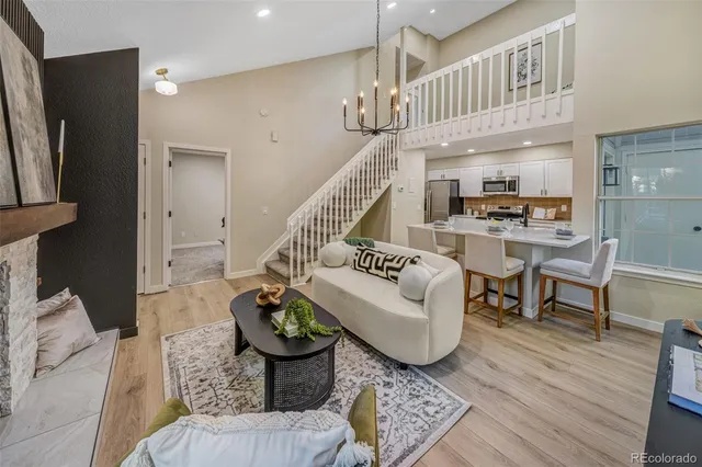 a living room with furniture and a chandelier