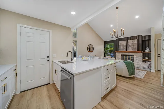 a kitchen with a sink appliances and cabinets