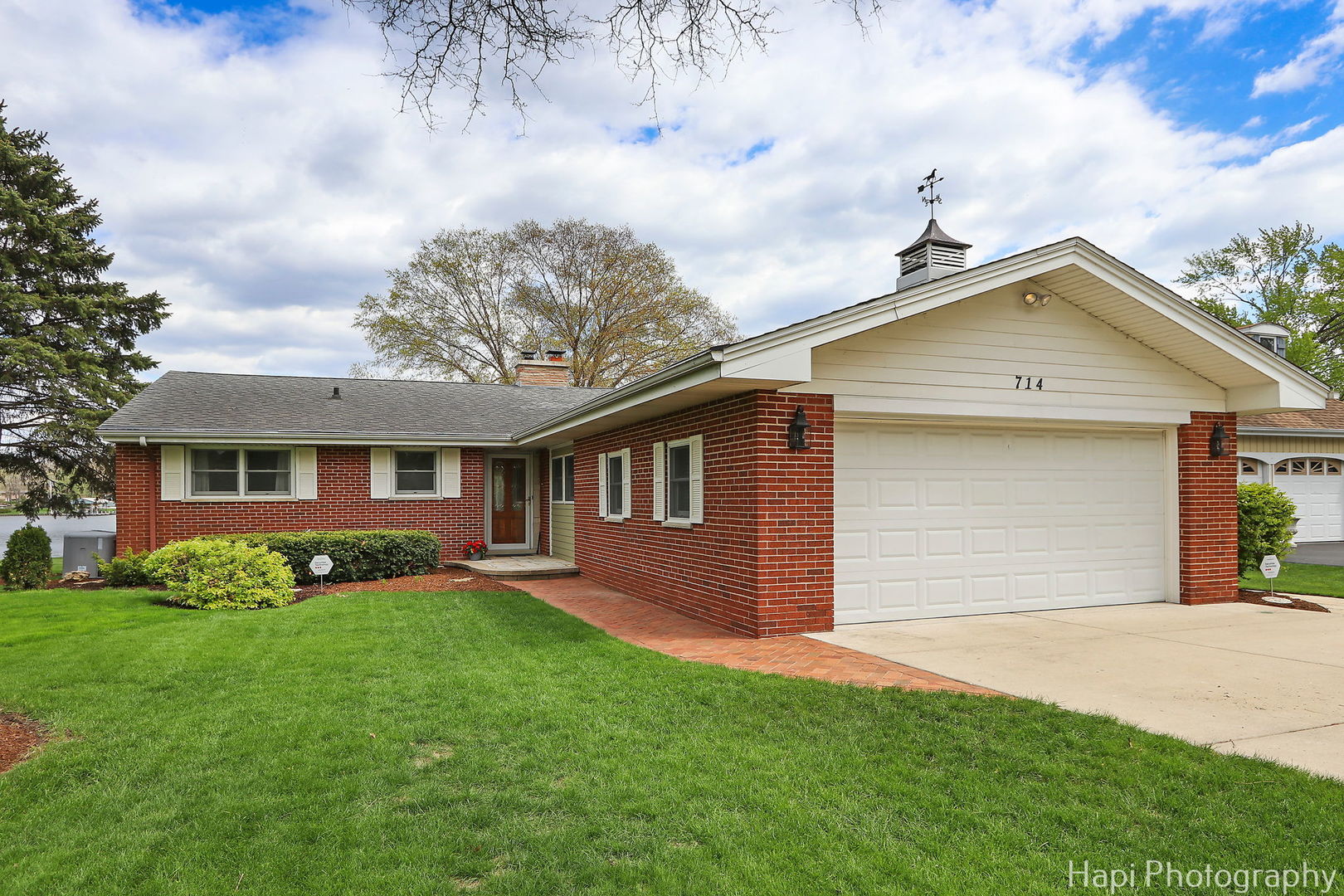 714 South Riverside Drive McHenry, IL 60050 - Photo 12 of 49 a front view of a house with a garden and yard