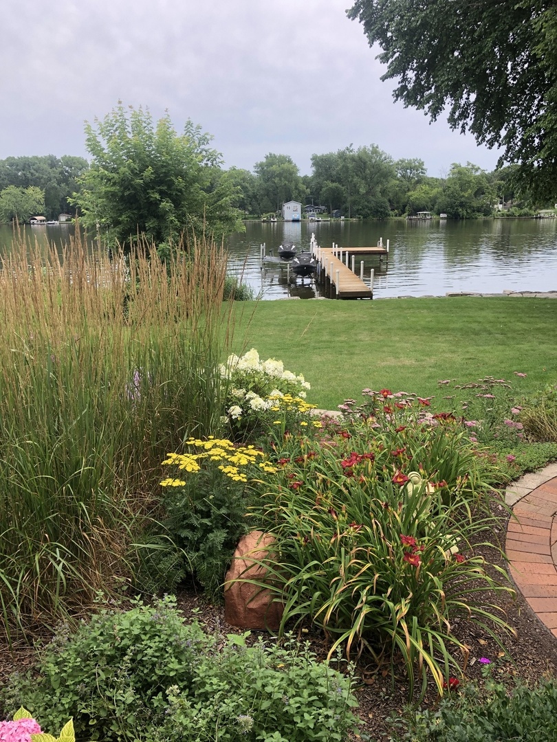 714 South Riverside Drive McHenry, IL 60050 - Photo 42 of 49 a view of a lake with a house in the background