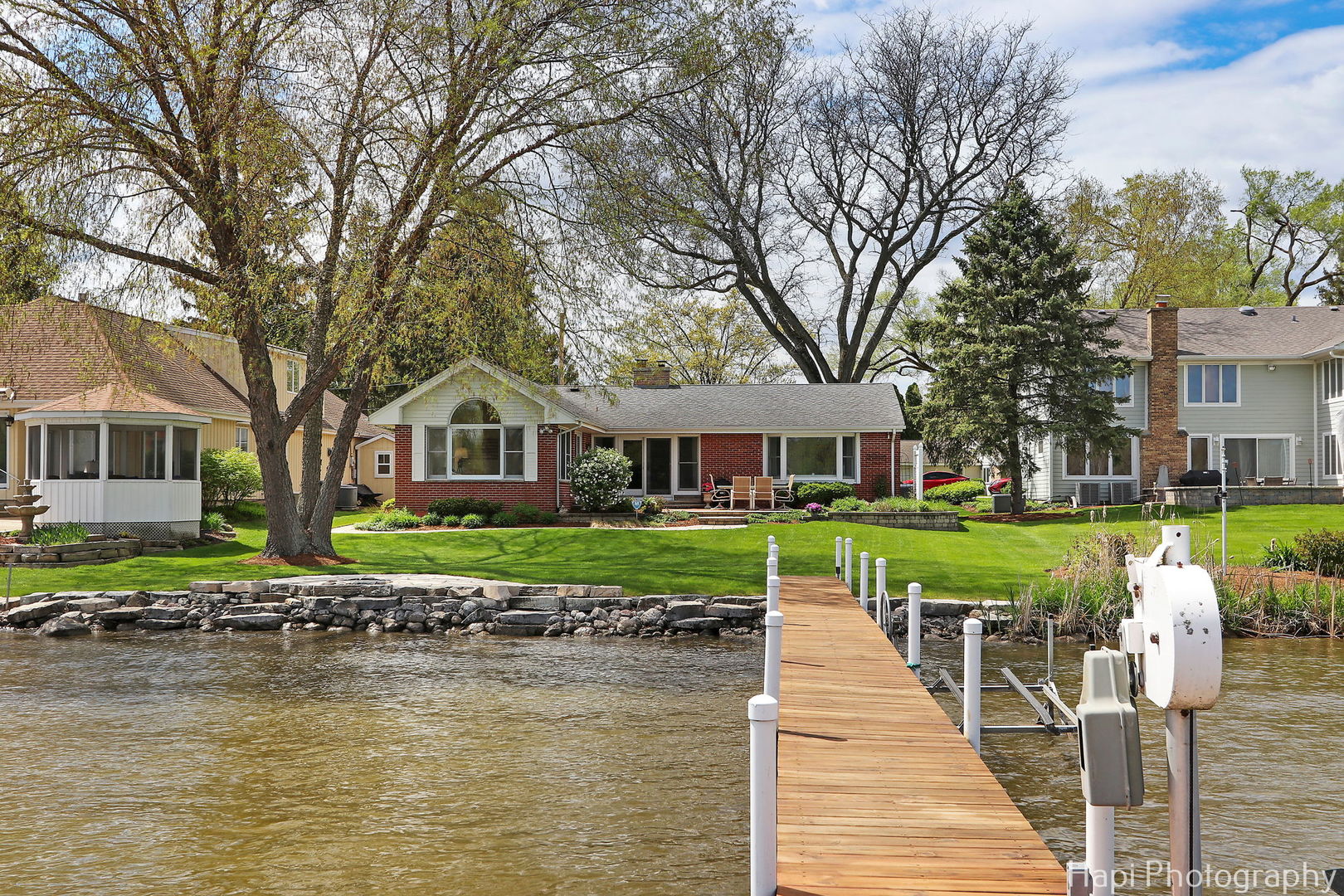 714 South Riverside Drive McHenry, IL 60050 - Photo 7 of 49 a front view of a house with a yard table and chairs