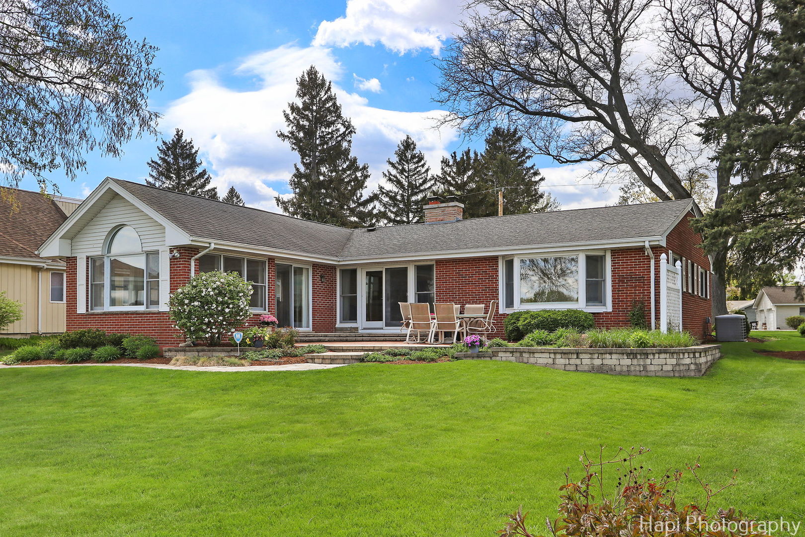 714 South Riverside Drive McHenry, IL 60050 - Photo 8 of 49 a front view of a house with a yard and trees