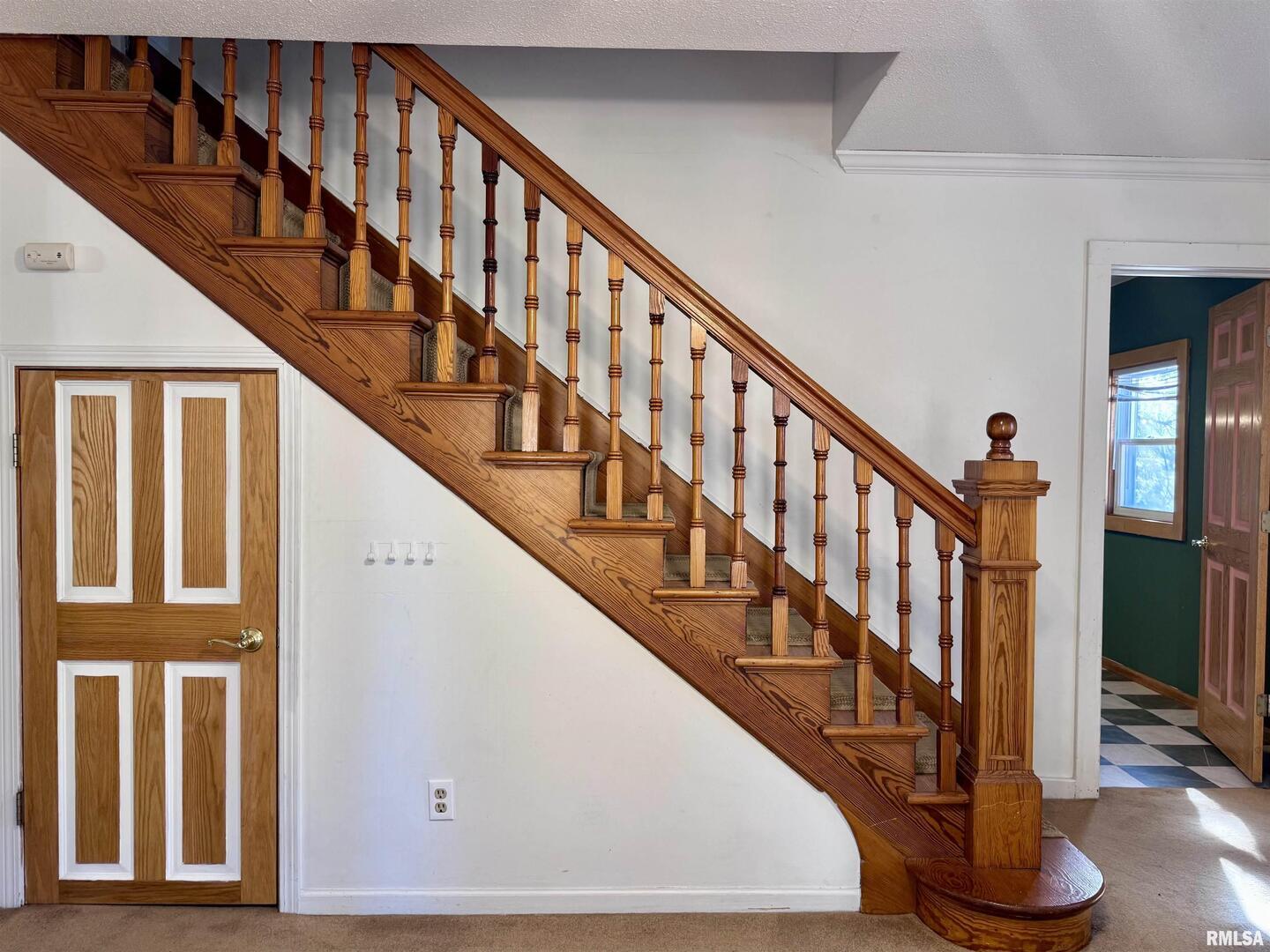 2711 North 2nd Street Clinton, IA 52732 - Photo 13 of 24 a view of staircase with lots of frames on wall and a window