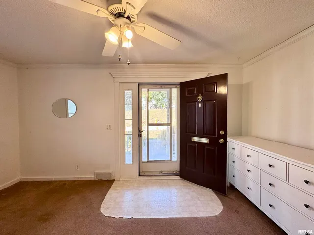 an empty room with windows and cabinet
