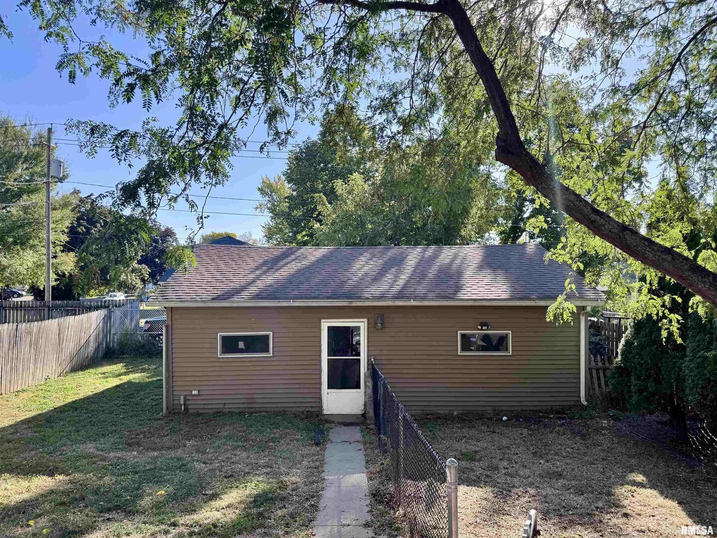2711 North 2nd Street Clinton, IA 52732 - Photo 2 of 24 a house that has a tree in front of it
