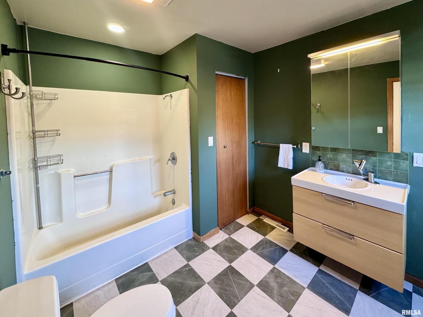 2711 North 2nd Street Clinton, IA 52732 - Photo 23 of 24 a bathroom with a sink a toilet and shower