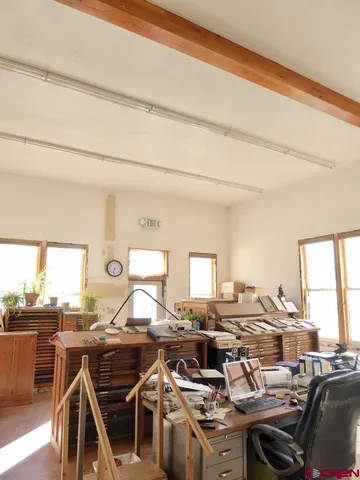a view of living room with furniture and a fireplace