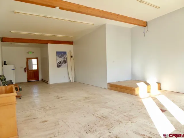 a view of a dining room with furniture and a floor to ceiling window