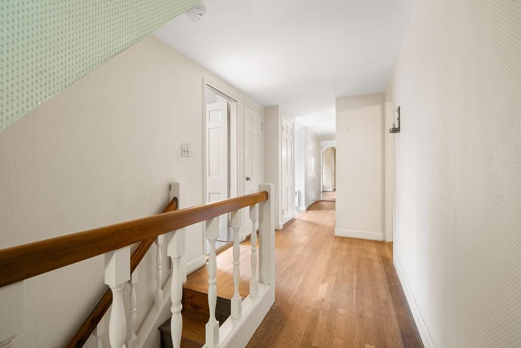 28 Montvale Road Weston, MA 02493 - Photo 25 of 26 a view of a hallway with wooden floor and staircase
