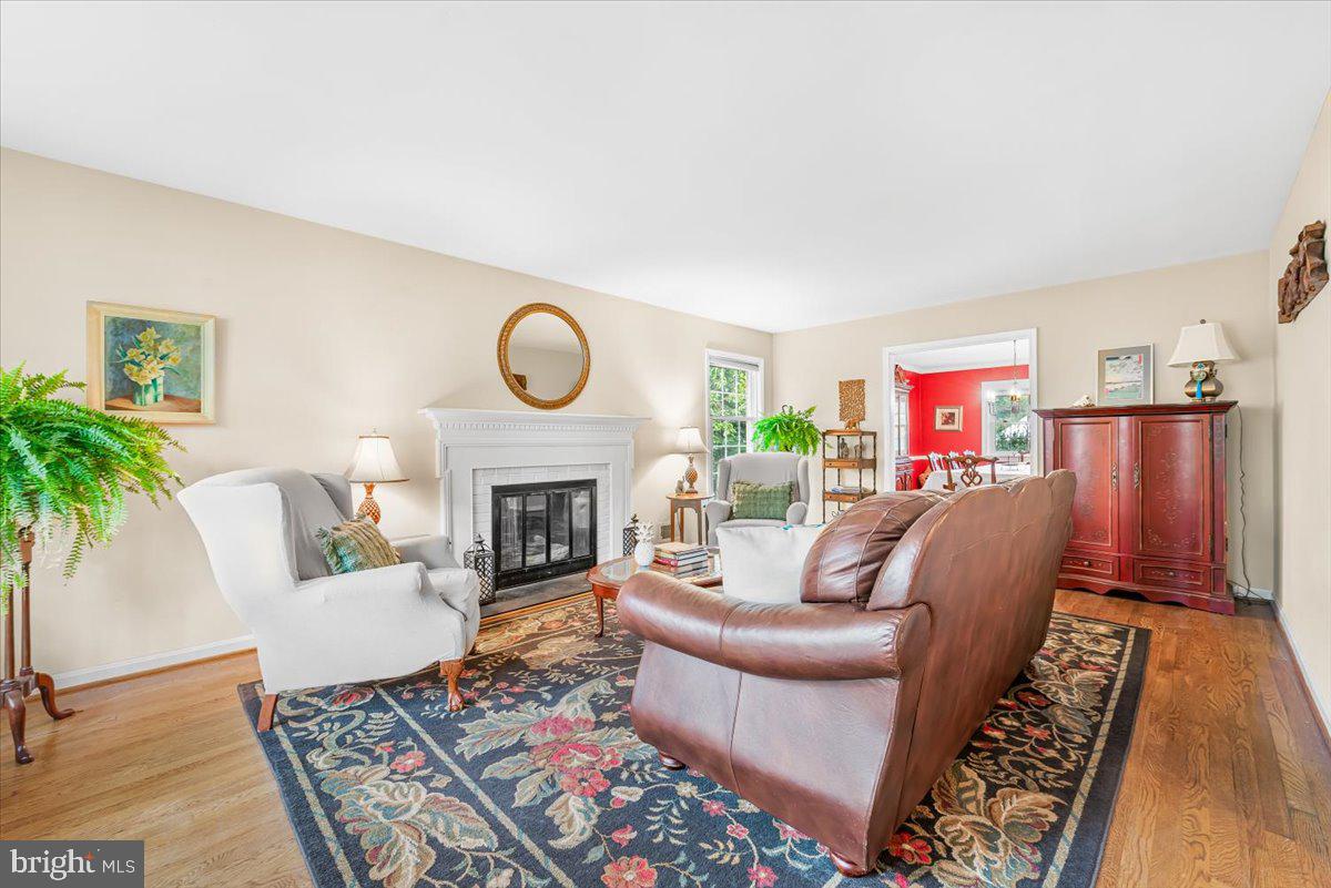 9809 Canal Road Gaithersburg, MD 20886 - Photo 14 of 50 a living room with furniture a fireplace and a potted plant