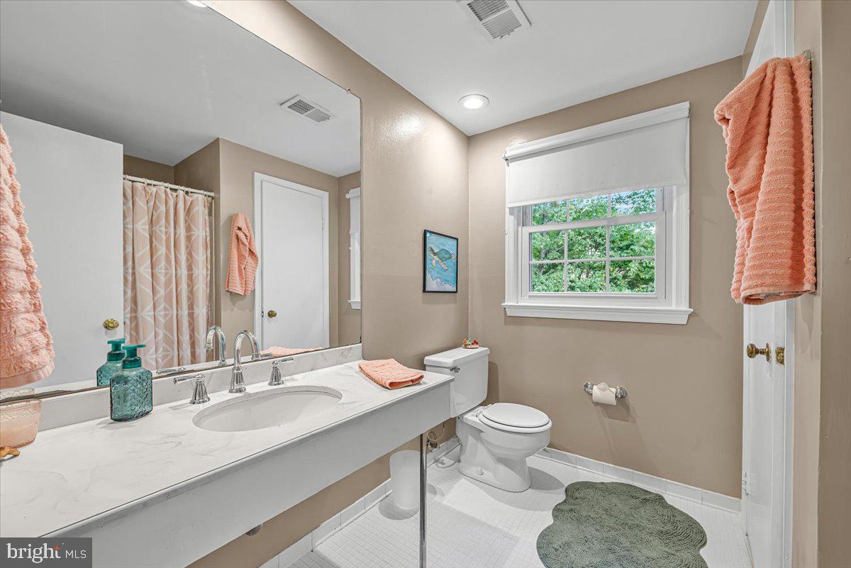 9809 Canal Road Gaithersburg, MD 20886 - Photo 28 of 50 a bathroom with a granite countertop sink toilet and shower