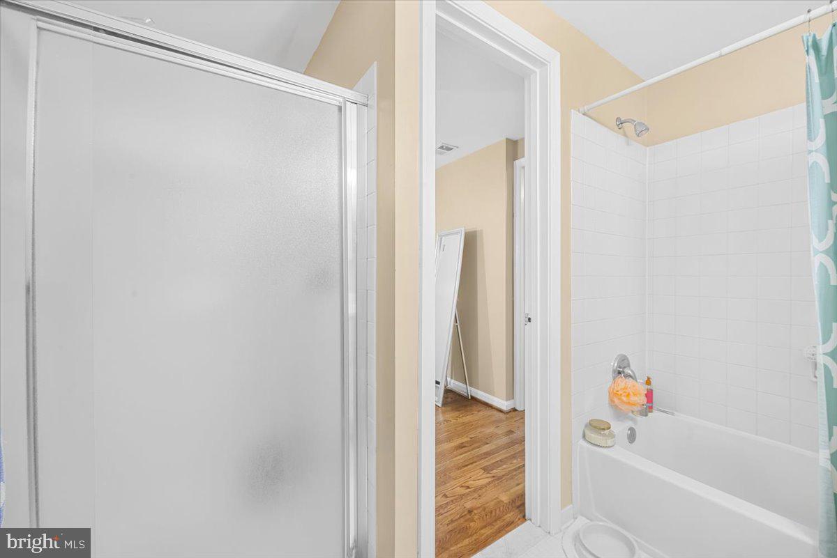 9809 Canal Road Gaithersburg, MD 20886 - Photo 32 of 50 a bathroom with a bathtub and a shower