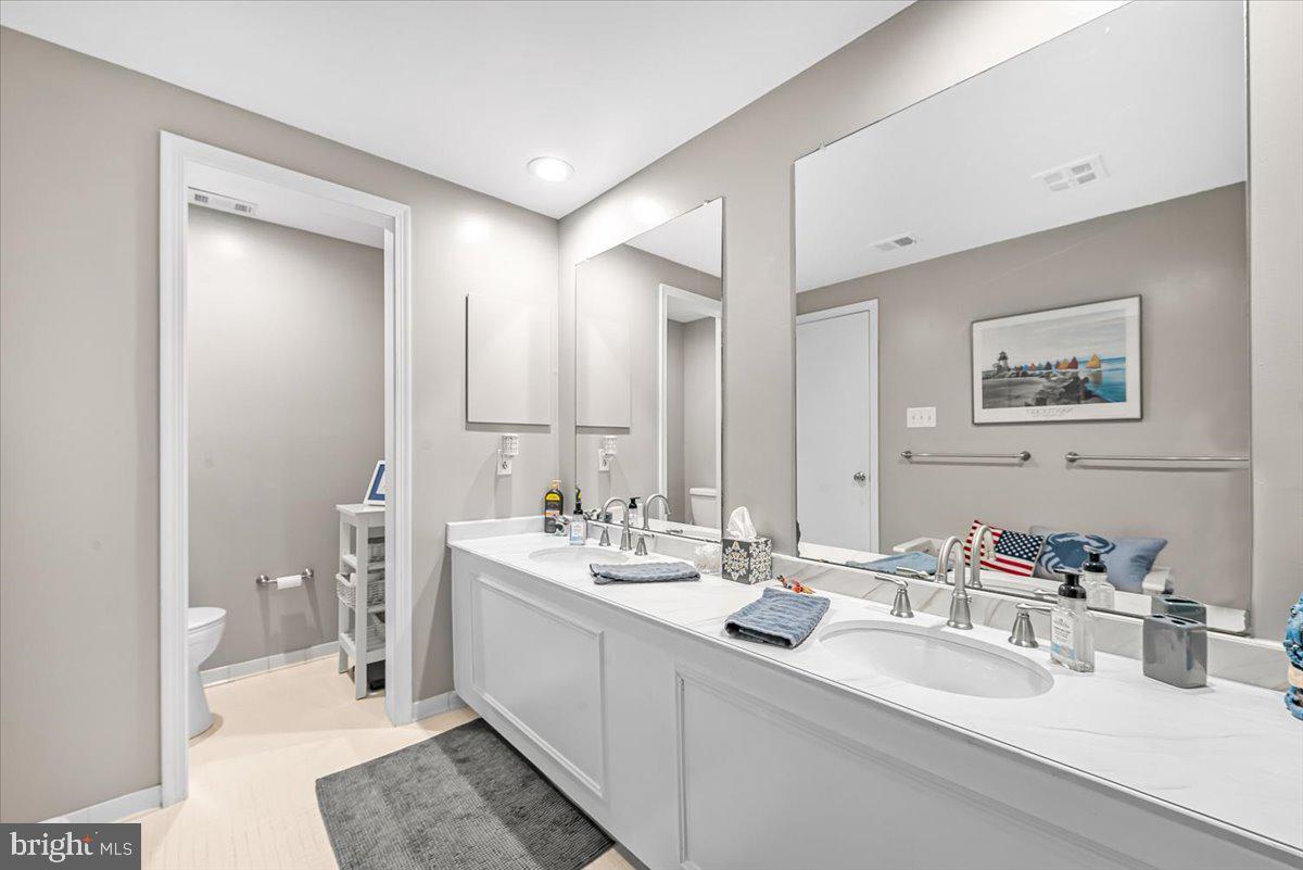 9809 Canal Road Gaithersburg, MD 20886 - Photo 36 of 50 a bathroom with double vanity sinks double vanity and mirror