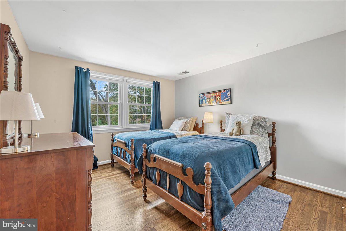 9809 Canal Road Gaithersburg, MD 20886 - Photo 37 of 50 a bedroom with a bed and a table in it