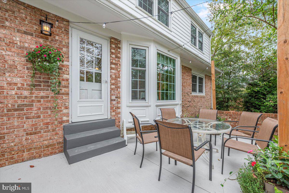 9809 Canal Road Gaithersburg, MD 20886 - Photo 44 of 50 a view of a patio with table and chairs and potted plants