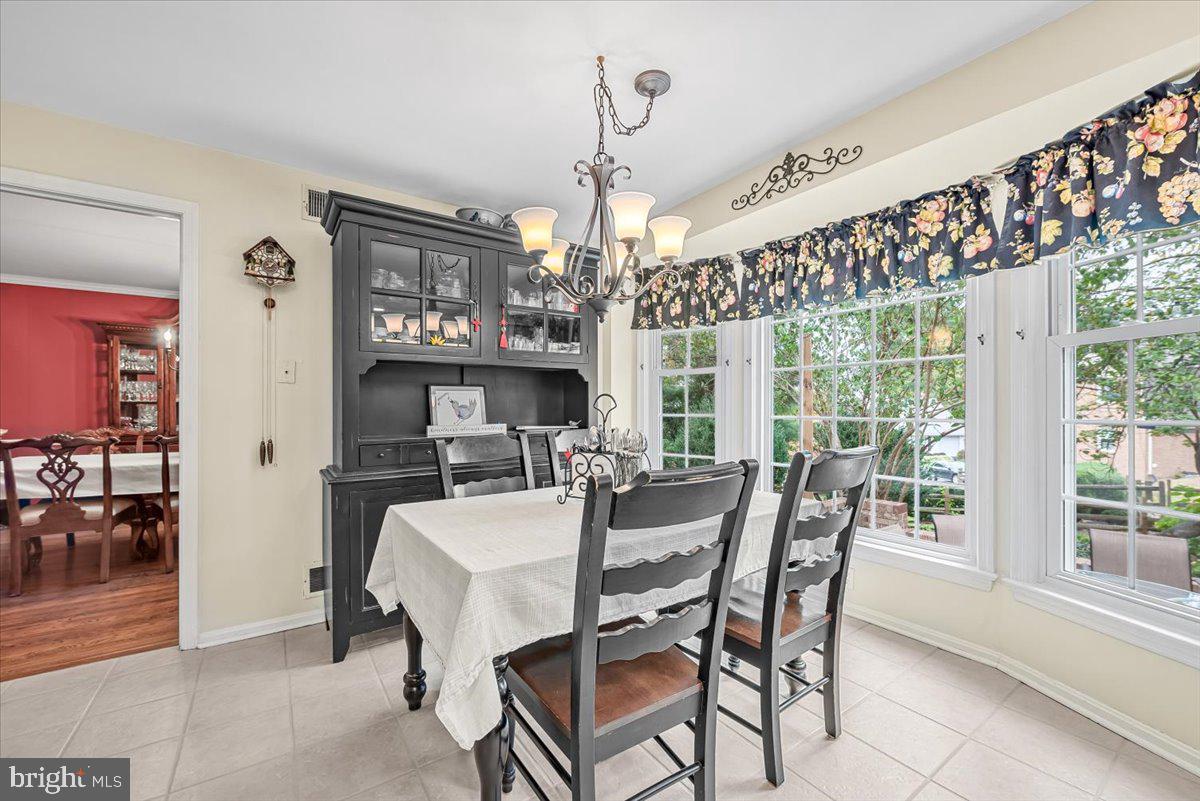 9809 Canal Road Gaithersburg, MD 20886 - Photo 7 of 50 a view of a dining room with furniture window and wooden floor