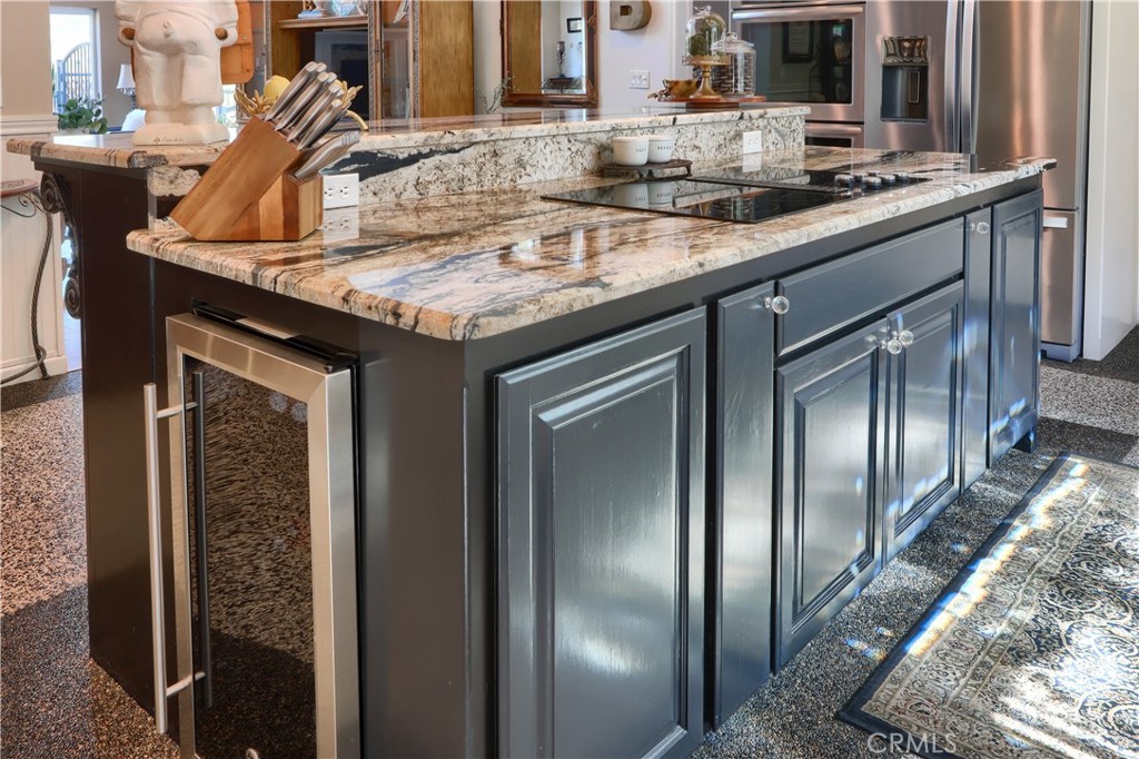 42038 Empty Creek Road Oakhurst, CA 93644 - Photo 16 of 66 built in wine refrigerator in kitchen island with breakfast bar