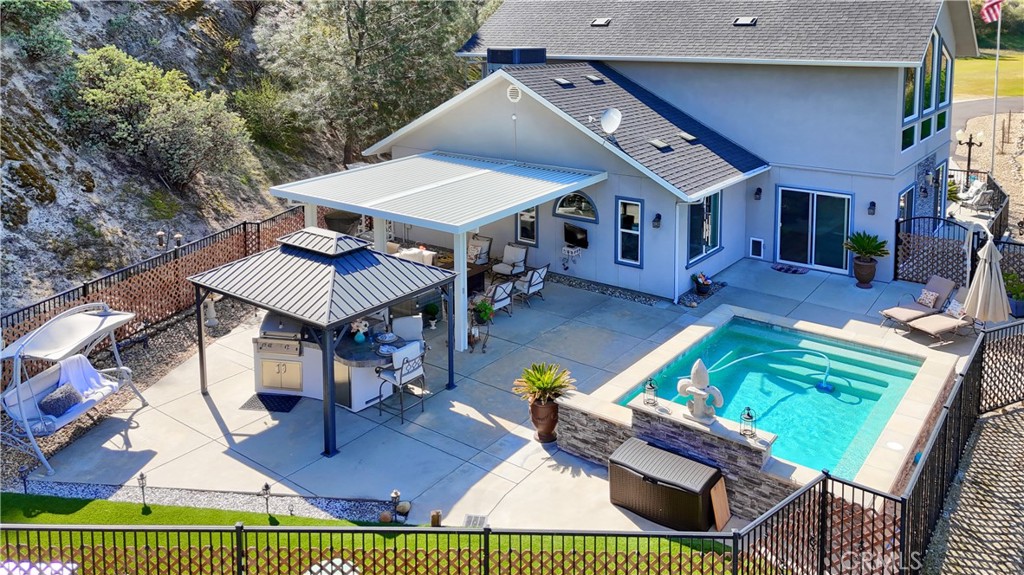 42038 Empty Creek Road Oakhurst, CA 93644 - Photo 37 of 66 backyard aerial view, synthetic grass and concrete patio for low maintenance