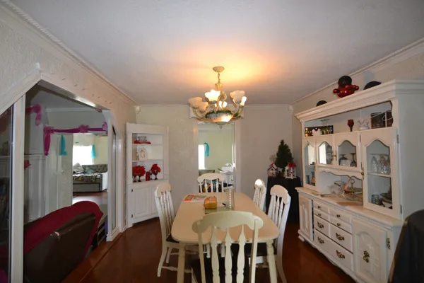 a view of a dining room with furniture and chandelier