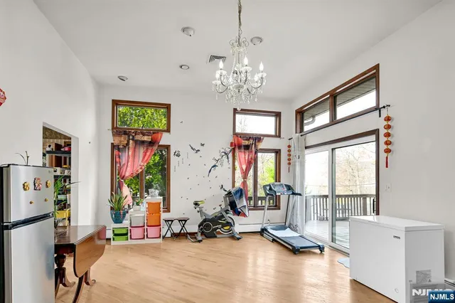 a view of a room with gym equipment and windows
