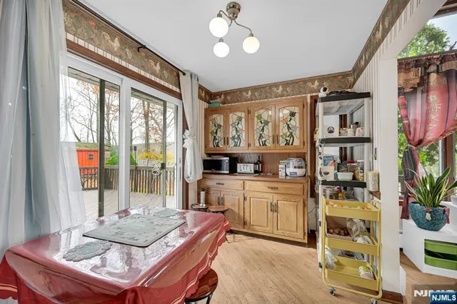 a kitchen with sink refrigerator and dining table