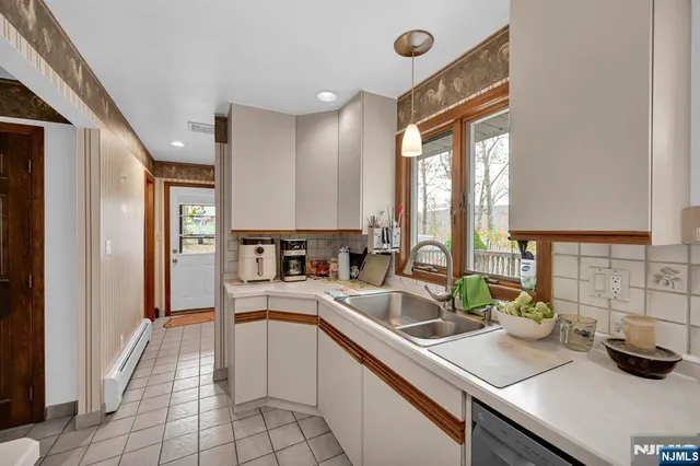 a kitchen with a sink appliances and cabinets