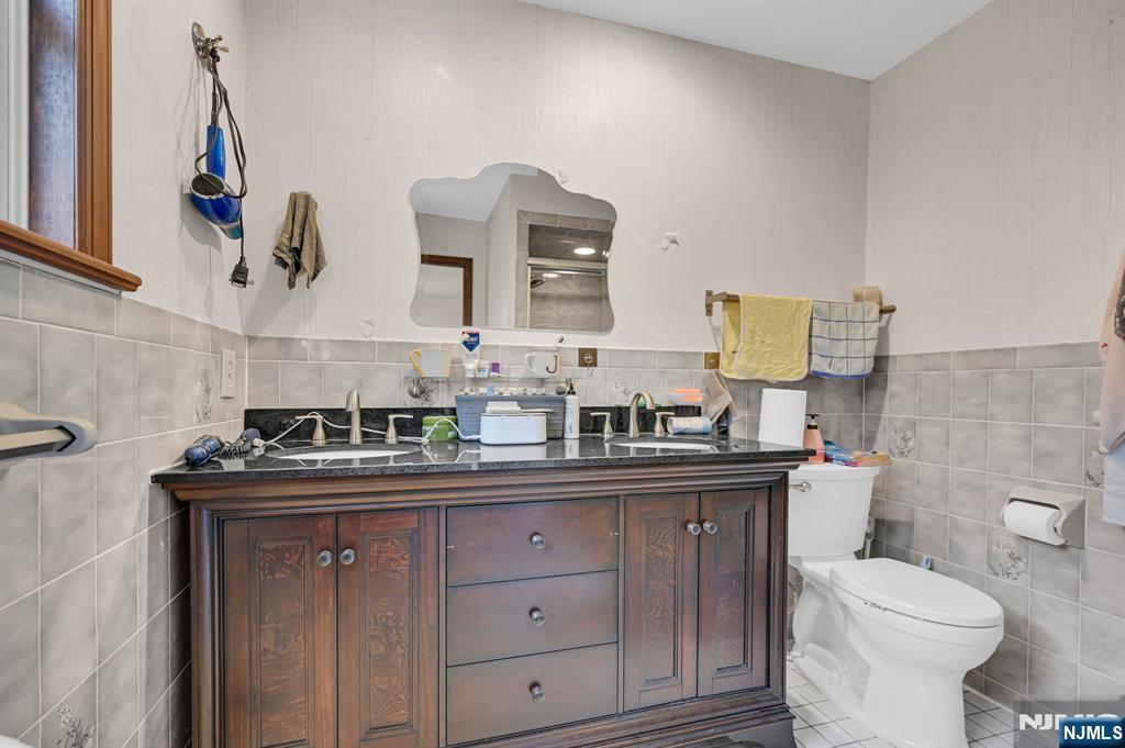 699 Shore Road West Milford, NJ 07421 - Photo 28 of 50 a bathroom with a toilet sink and mirror