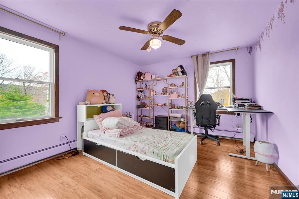 699 Shore Road West Milford, NJ 07421 - Photo 32 of 50 a bedroom with a bed and wooden floor